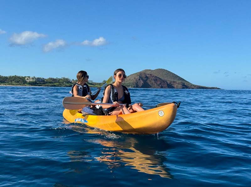 The Ultimate 3-Day Maui Adventure Plan for Kayak Lovers, featuring two girls kayaking together on the beautiful blue Maui ocean.